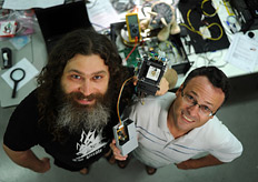 Vadim Makarov and Thomas Jennewein, holding a single-photon detector used in the teleportation experiment