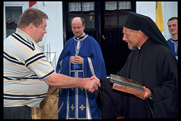 Neighbours congratulate monk Jonah after the consecration of the chapel